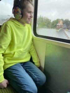 Boy on train with ear protetors