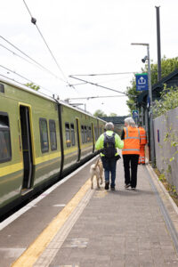 Man with Guide Dog and IR assistant on platform 400x600