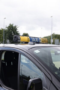 Taxi wheelchair sing on top of the car